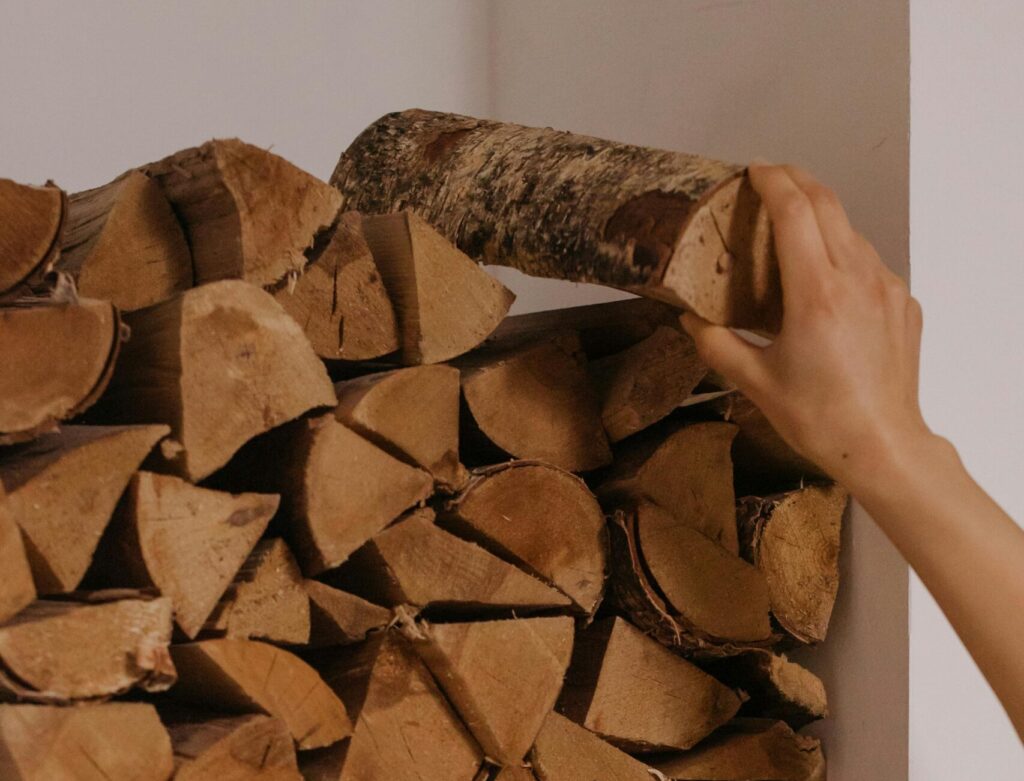 sauna wood A Person Staking Firewood, home sauna cost